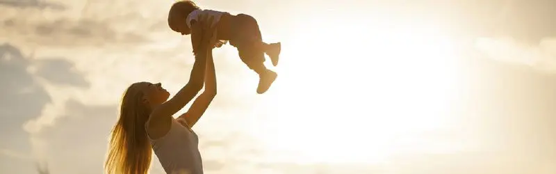 A person holding a child in the air