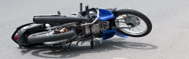 A motorcycle that has been hit by a car.