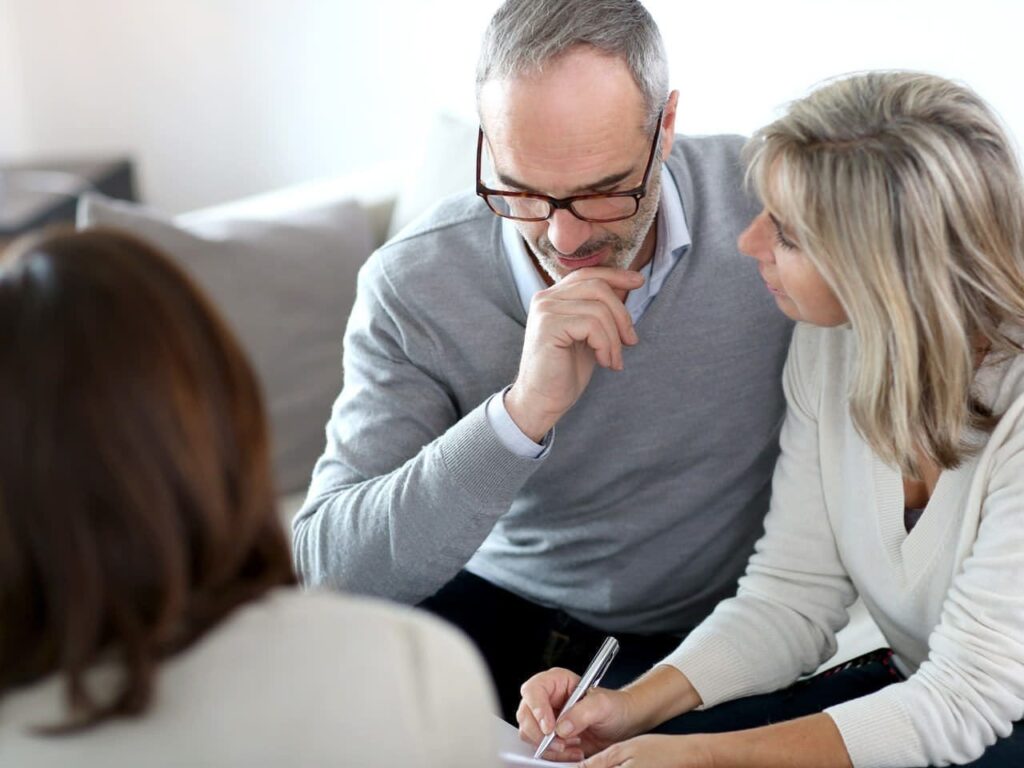 A man and woman sitting next to each other.