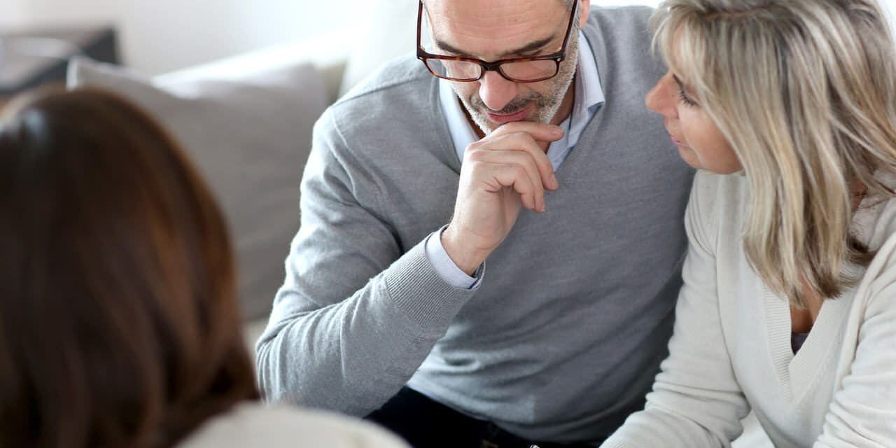 A man and woman sitting next to each other.