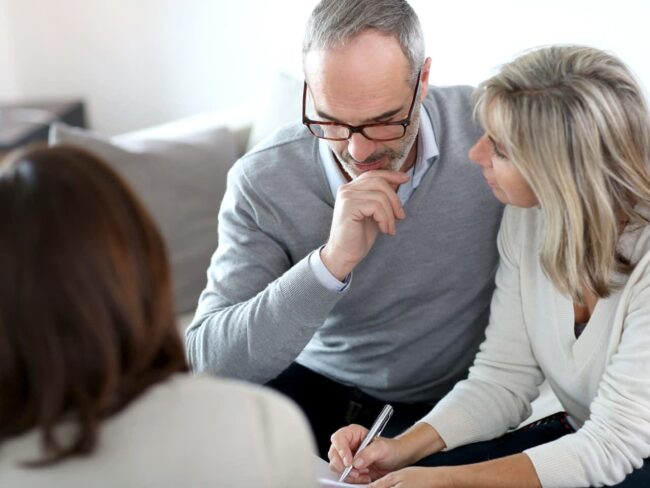 A man and woman sitting next to each other.