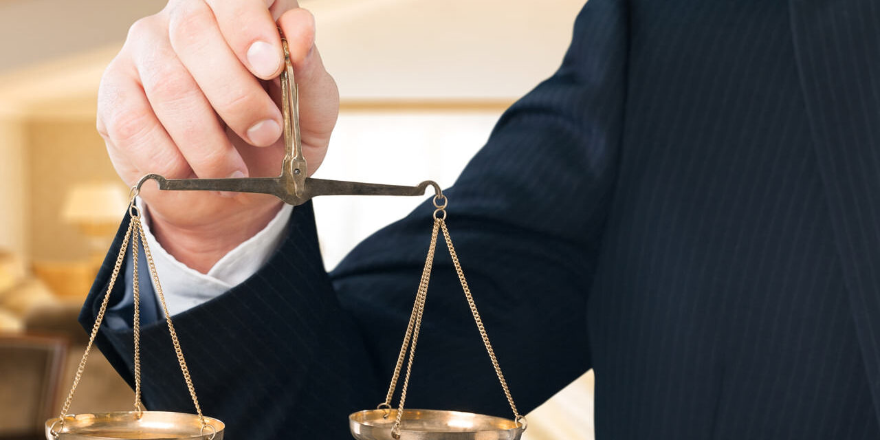 A person holding on to the scales of justice