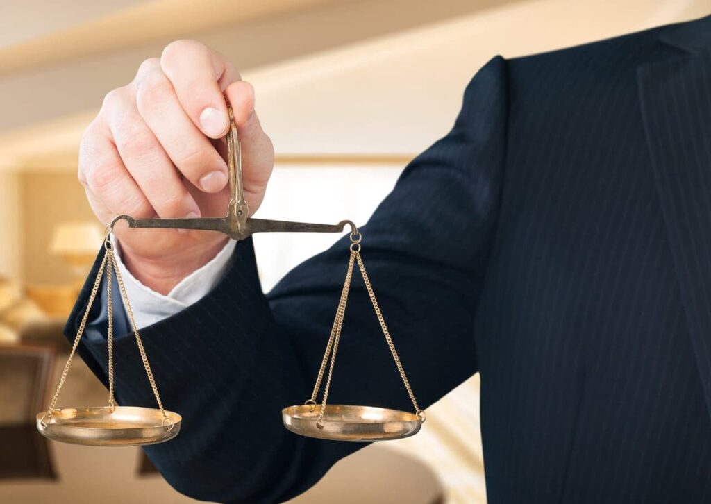 A person holding on to the scales of justice