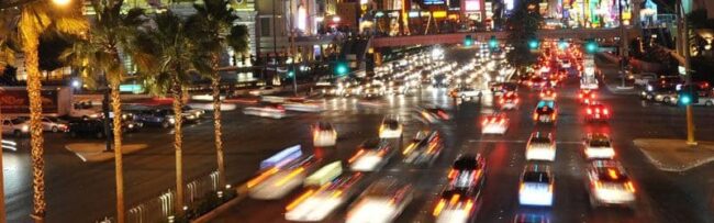 A busy city street with lots of traffic lights.