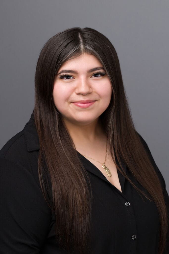 Woman with long hair wearing a black shirt.