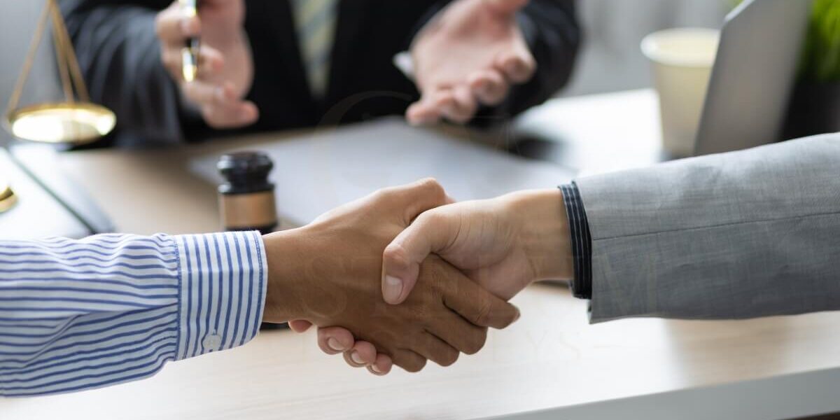 Handshake in a professional office setting.