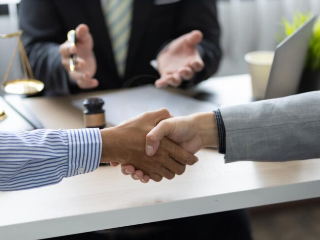 Handshake in a professional office setting.